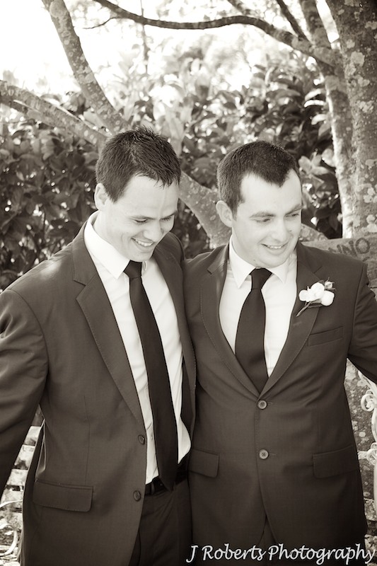 Groom and best man embrace after marriage ceremony - wedding photography sydney